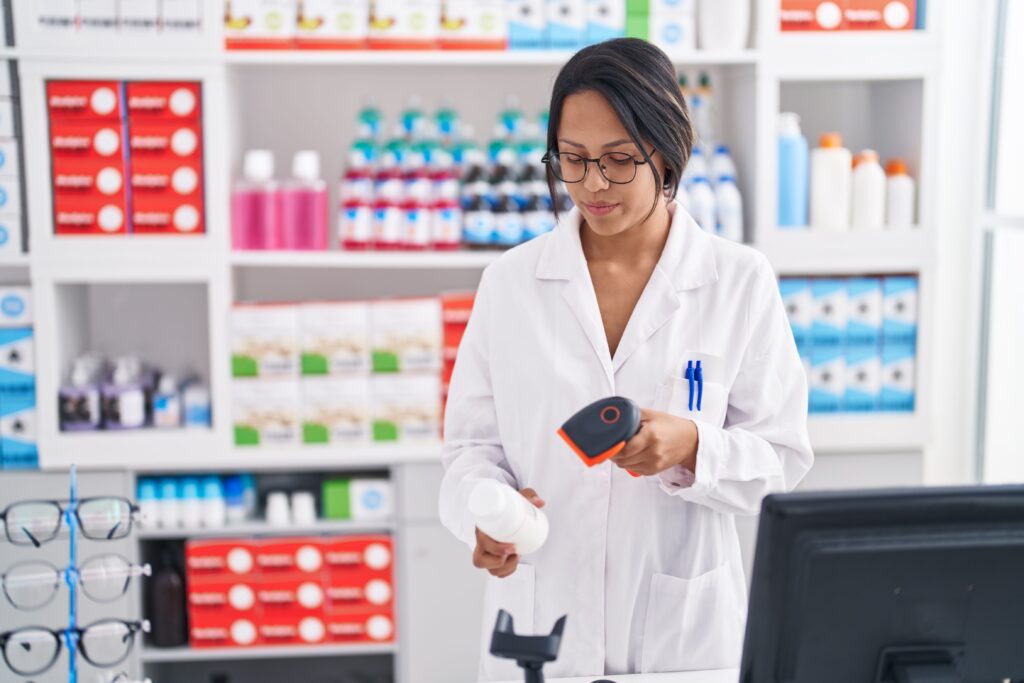 Young pharmacist scanning a medication.