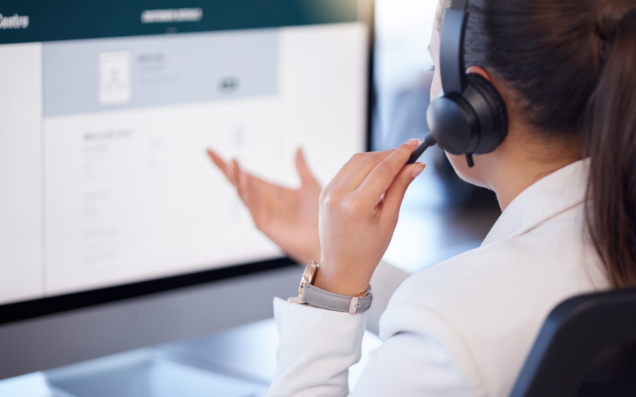 Pharmacist utilizing phone headset while on computer