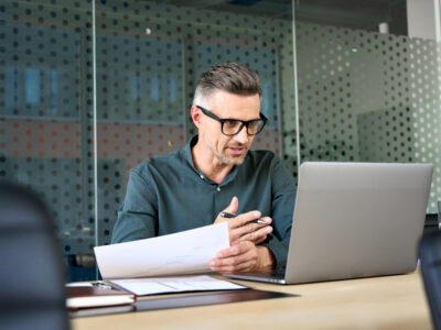 A mature businessman having a virtual meeting on his laptop.