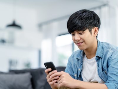 Man smiling holding phone