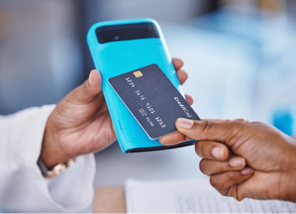 pharmacist charging patient credit card, using merchant services